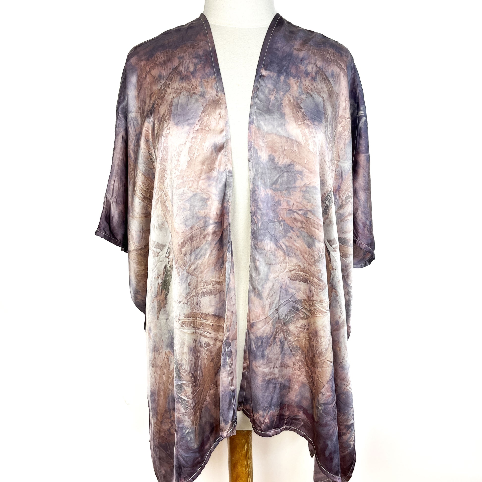Front view of a Short Silk Cardigan with abstract botanical pattern and an open, draped design.