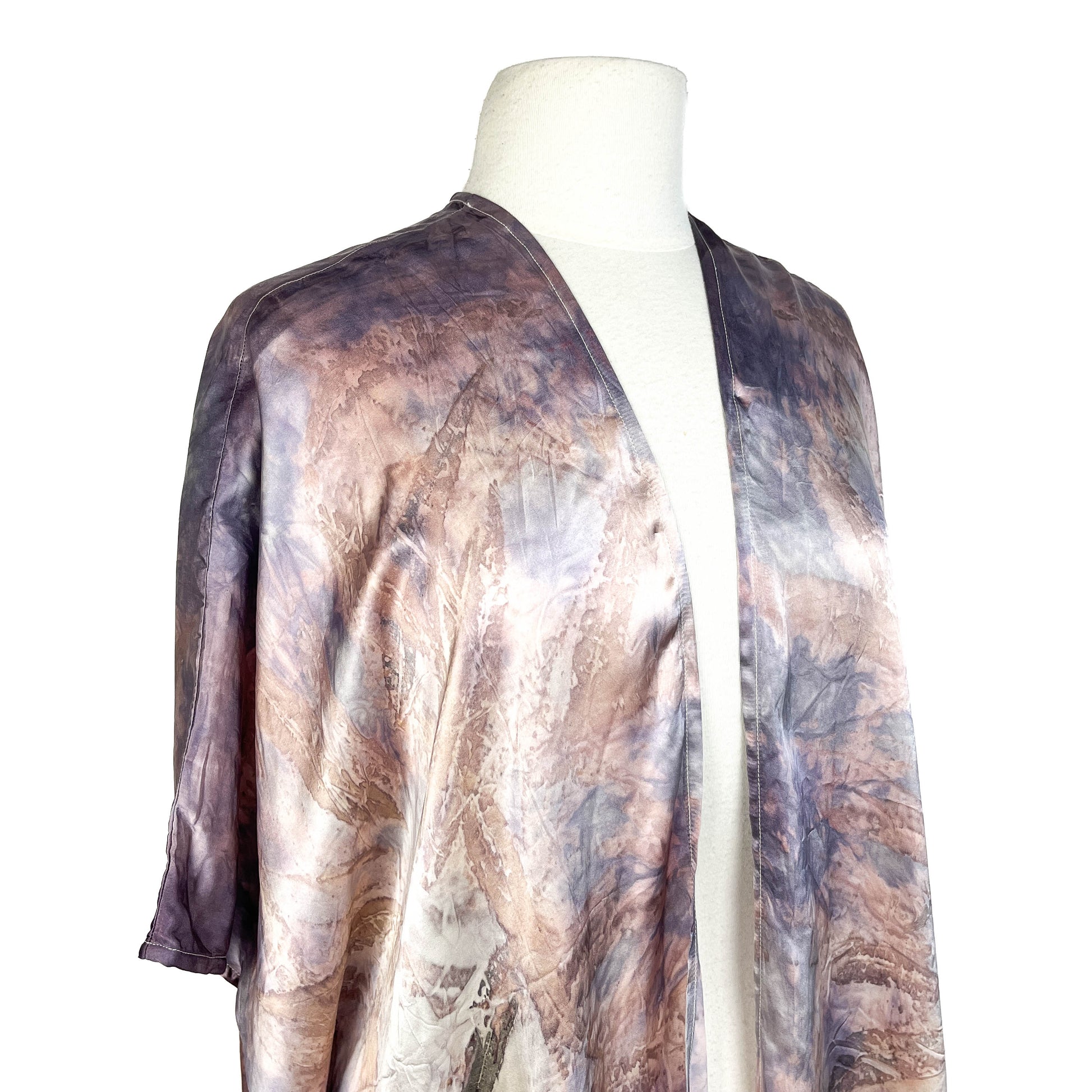 Angled view of Short Silk Cardigan showing fluid shape, flowing sleeves, and organic surface pattern.