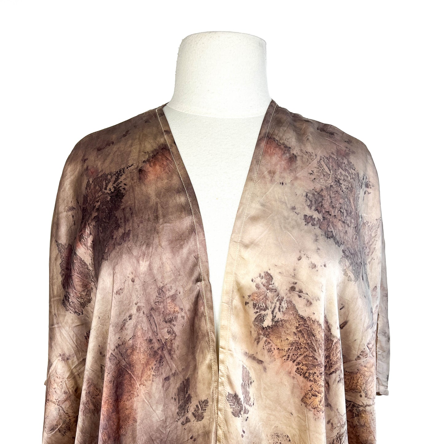 Close-up of Short Silk Cardigan showing delicate leaf patterns and detailed stitching around the neckline.
