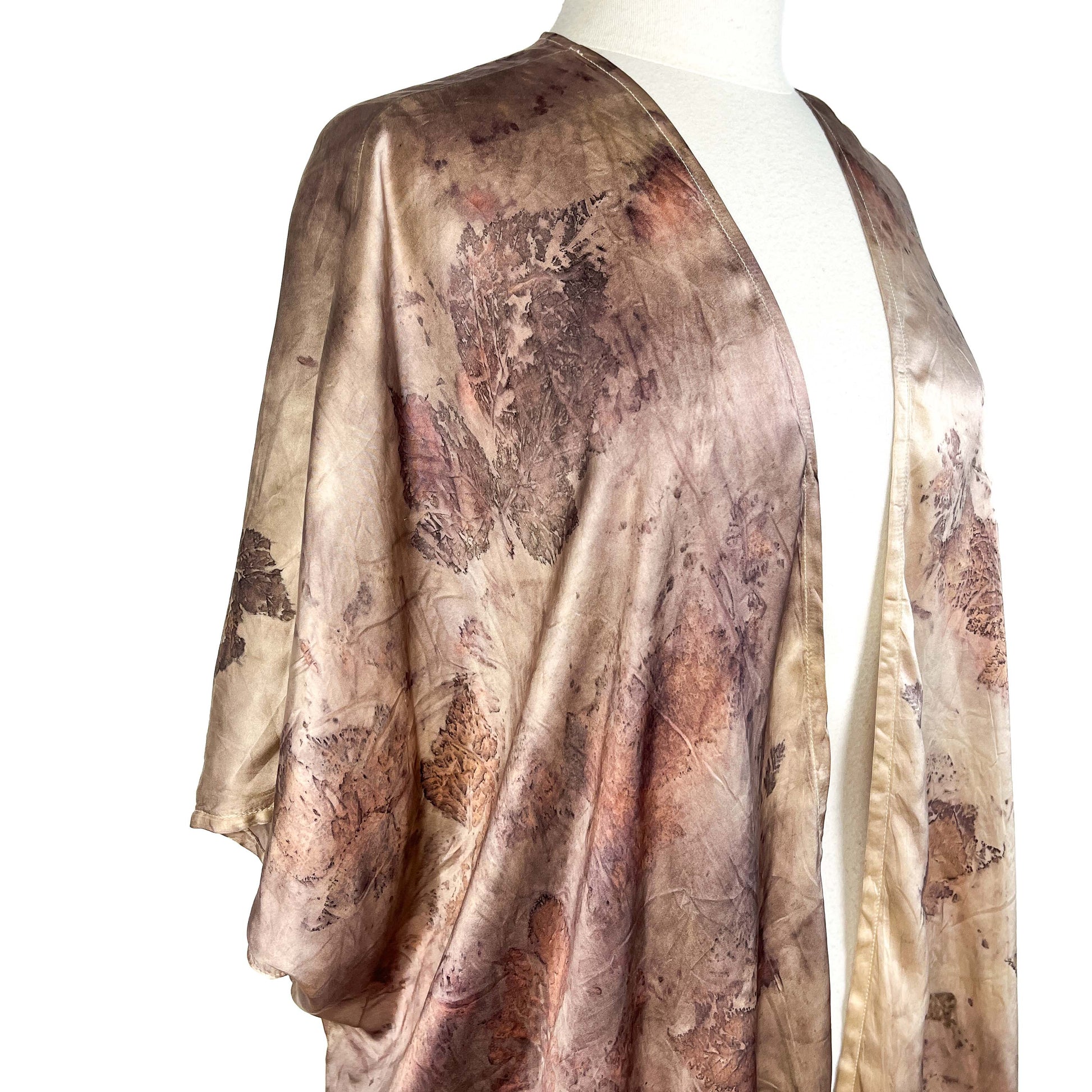 Angled view of Short Silk Cardigan highlighting flowing fabric and organically dyed leaf impressions.