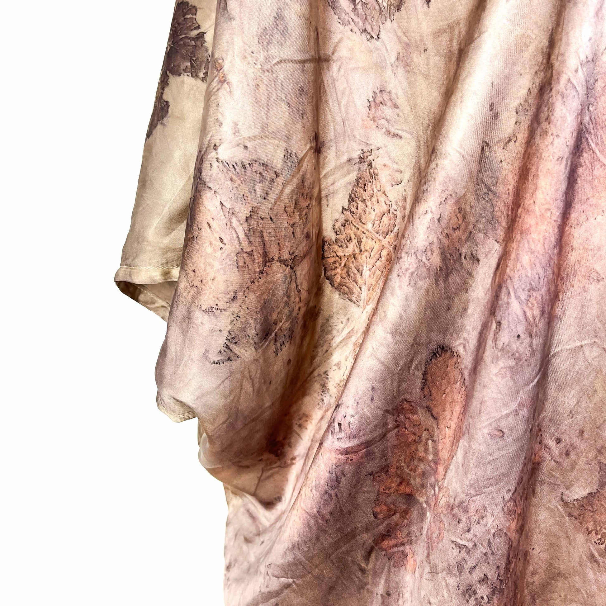Lower portion of Short Silk Cardigan featuring layered leaf prints and smooth silk drape.