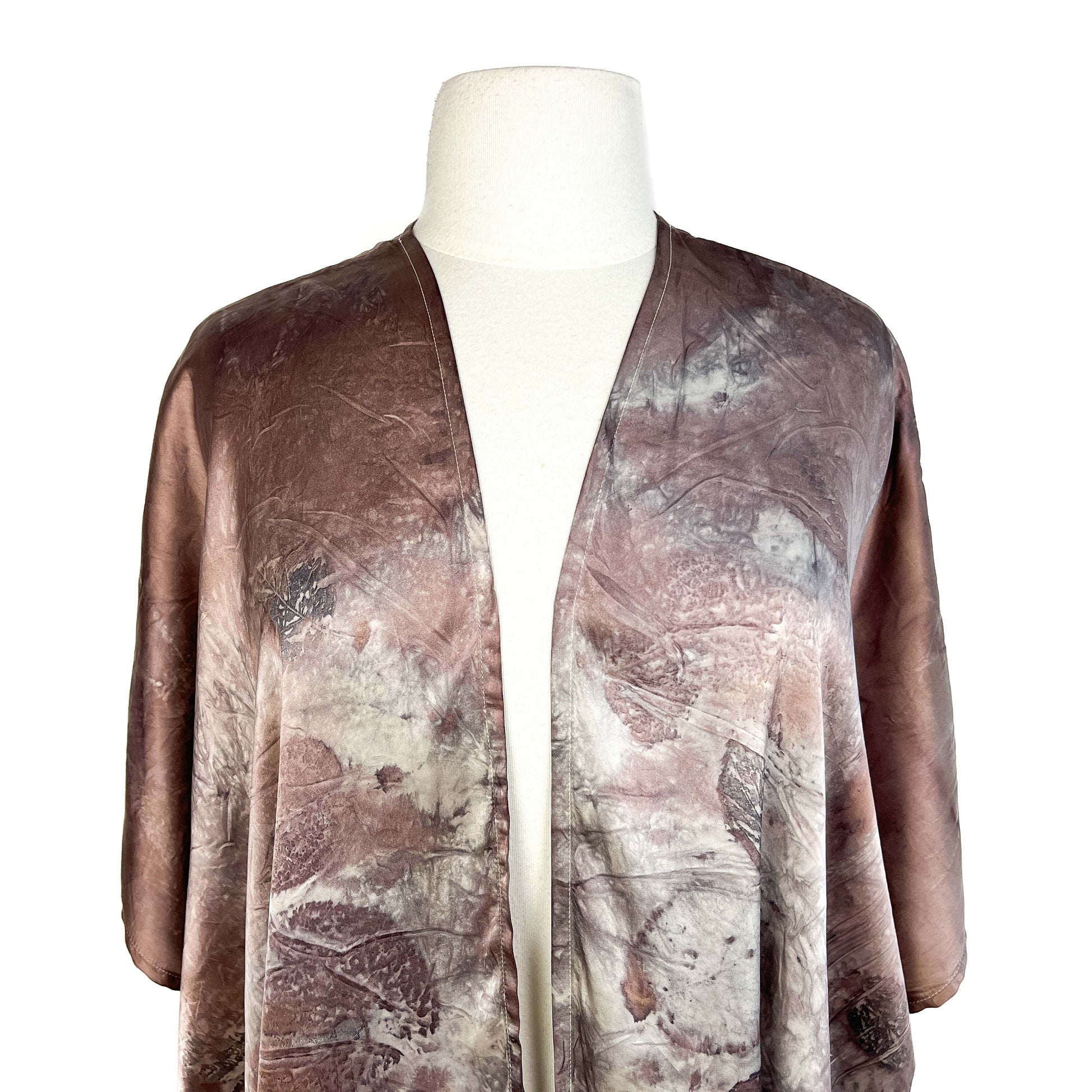 Upper section of Short Silk Cardigan showing seamless blend of colors and finely printed natural shapes.
