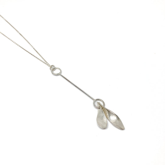Silver necklace with two leaf-shaped pendants, angled view.