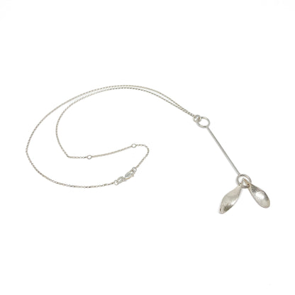 Silver necklace with leaf pendants, chain detail visible, angled.