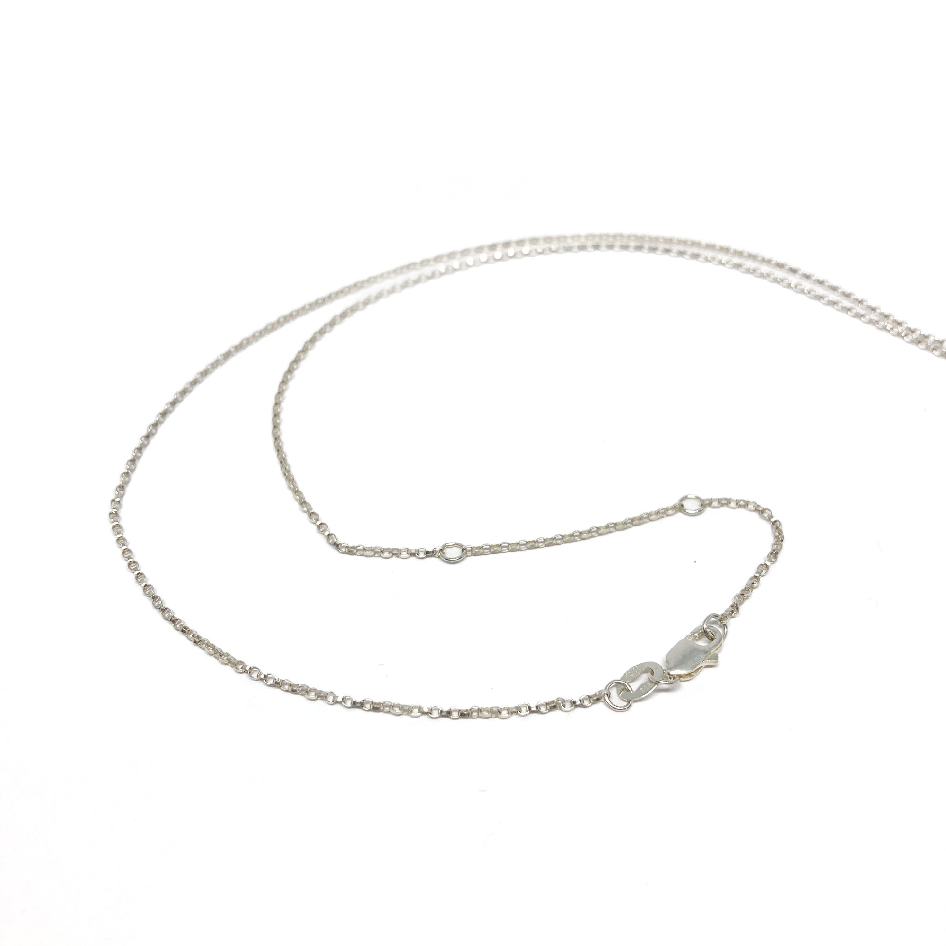 Silver necklace chain, close-up with clasp detail visible.