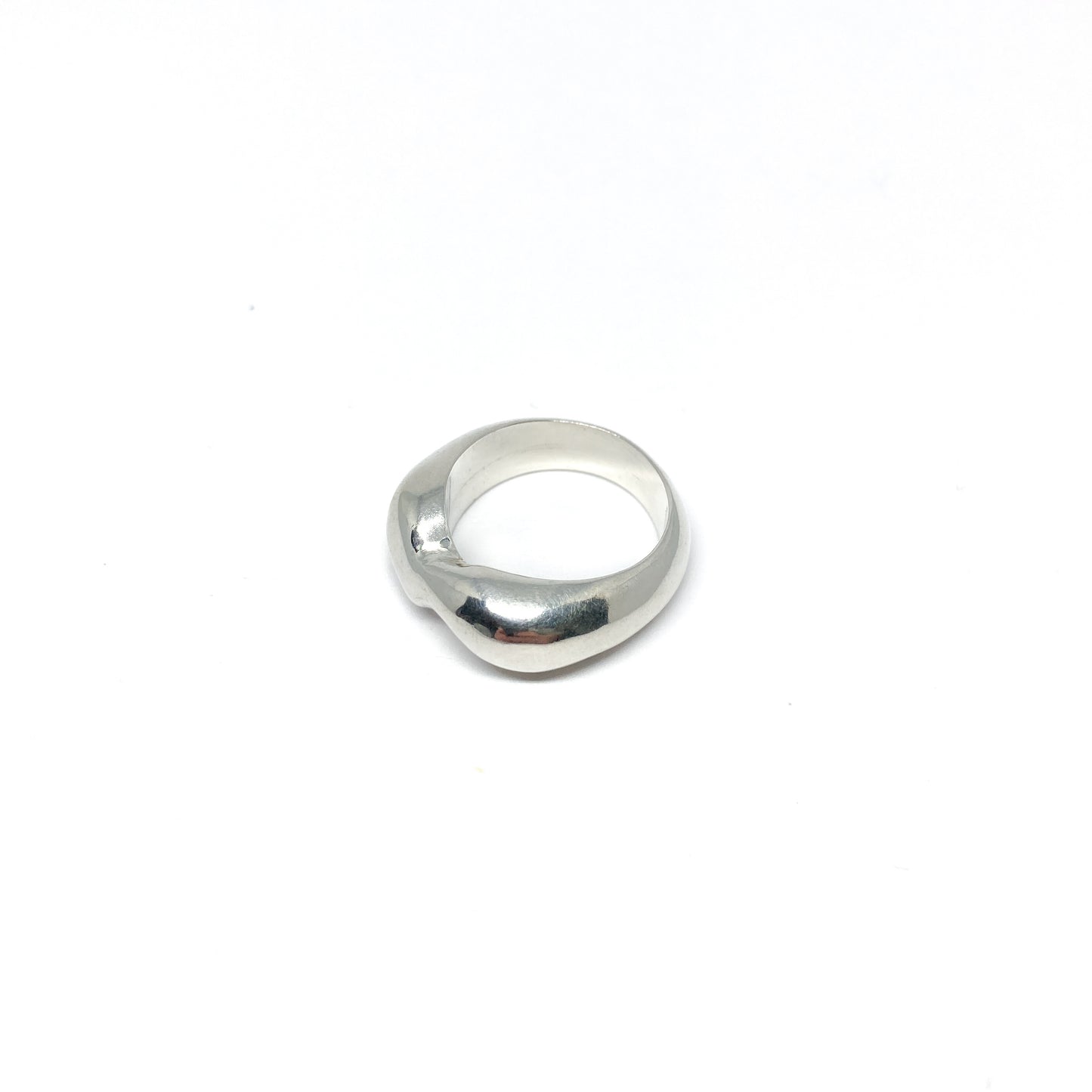 Modern silver ring with a curved, sculptural design.