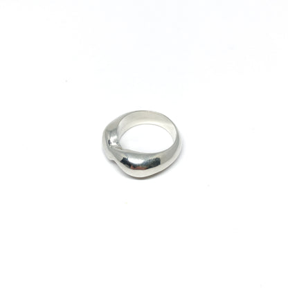 Modern silver ring with a curved, sculptural design.