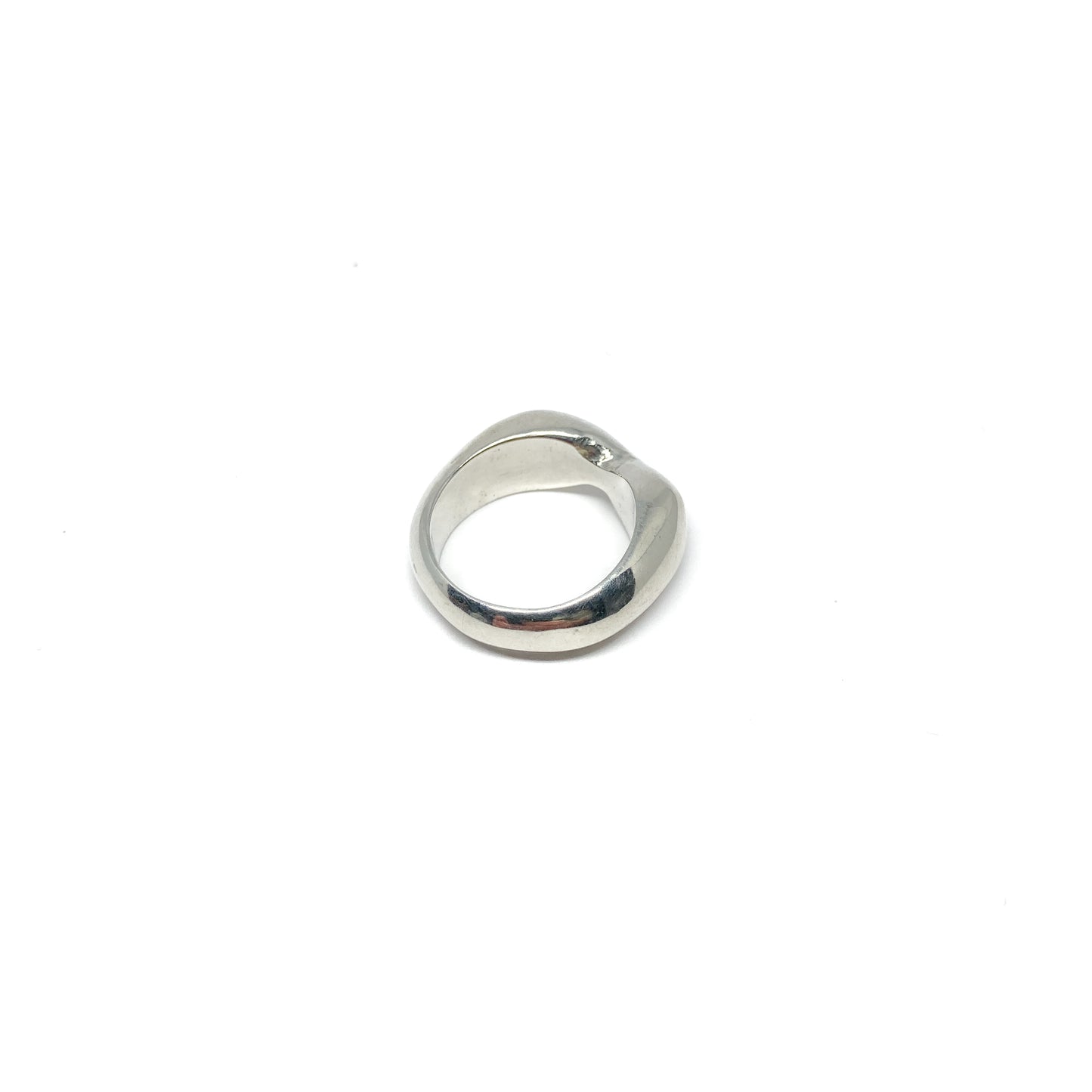 Modern silver ring with a curved, sculptural design.