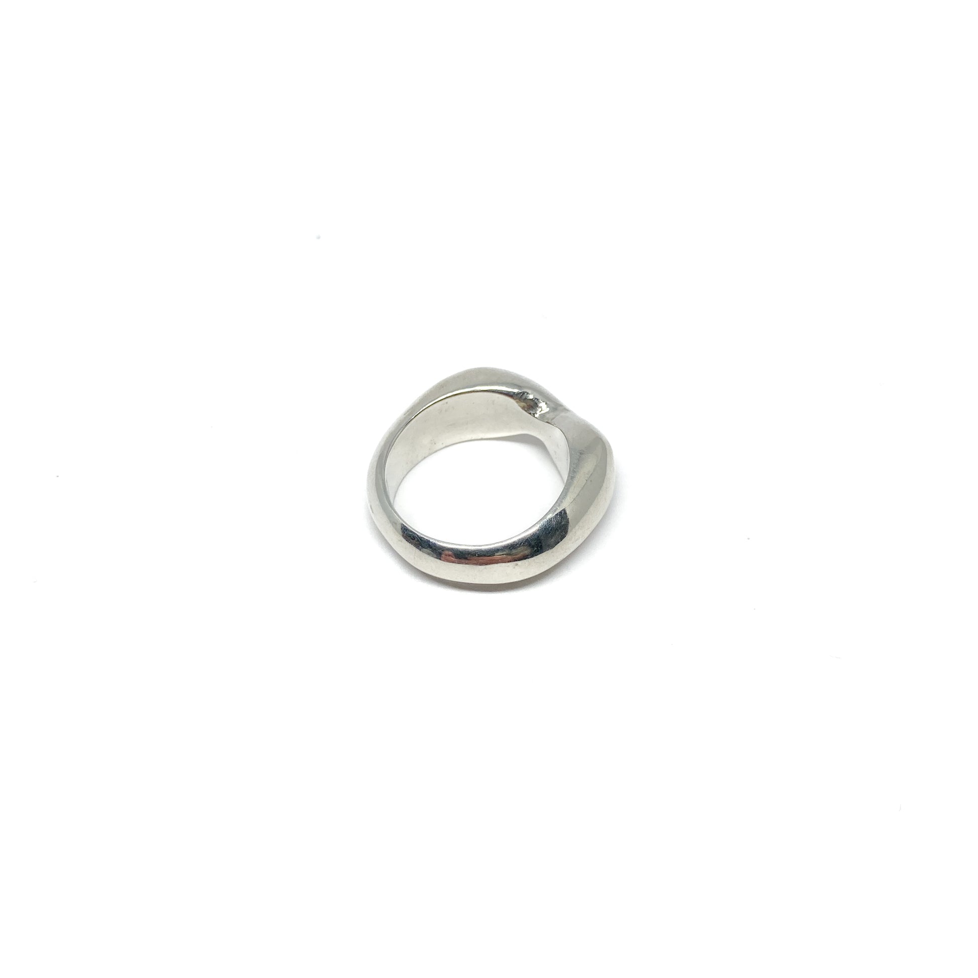 Modern silver ring with a curved, sculptural design.