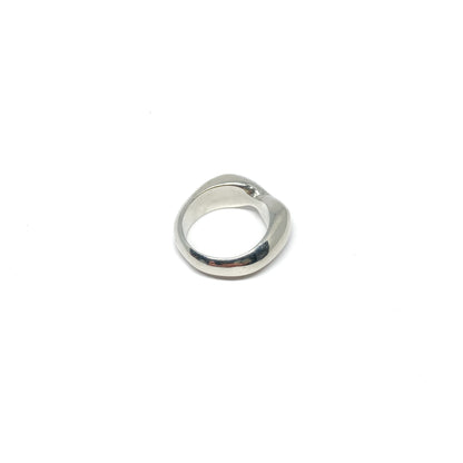 Modern silver ring with a curved, sculptural design.