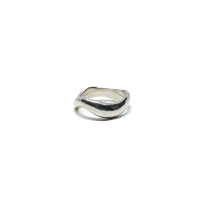 Modern silver ring with a fluid, sculptural design.