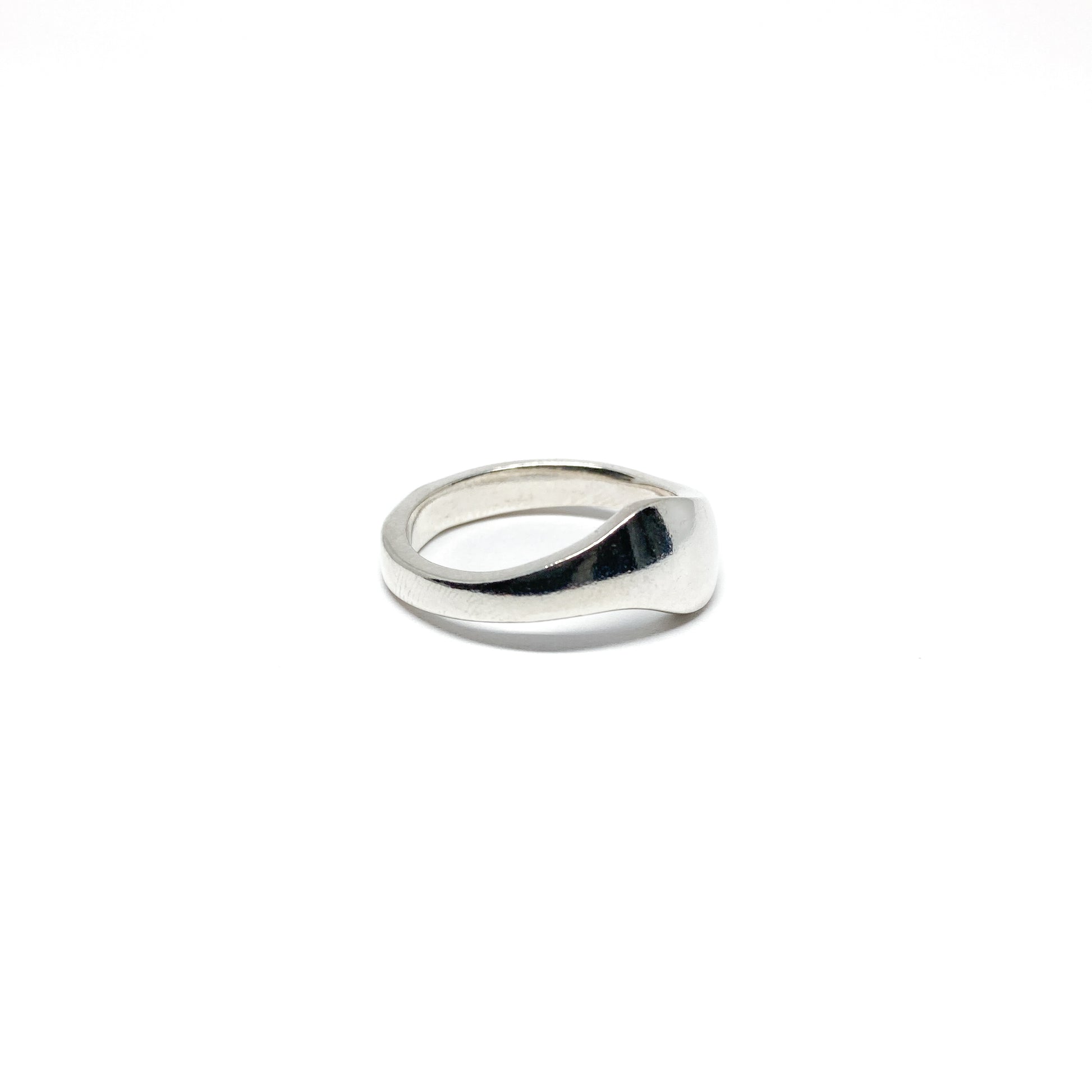 Modern silver ring with a smooth, curved design.