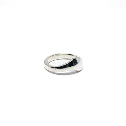 Modern silver ring with a smooth, curved design.