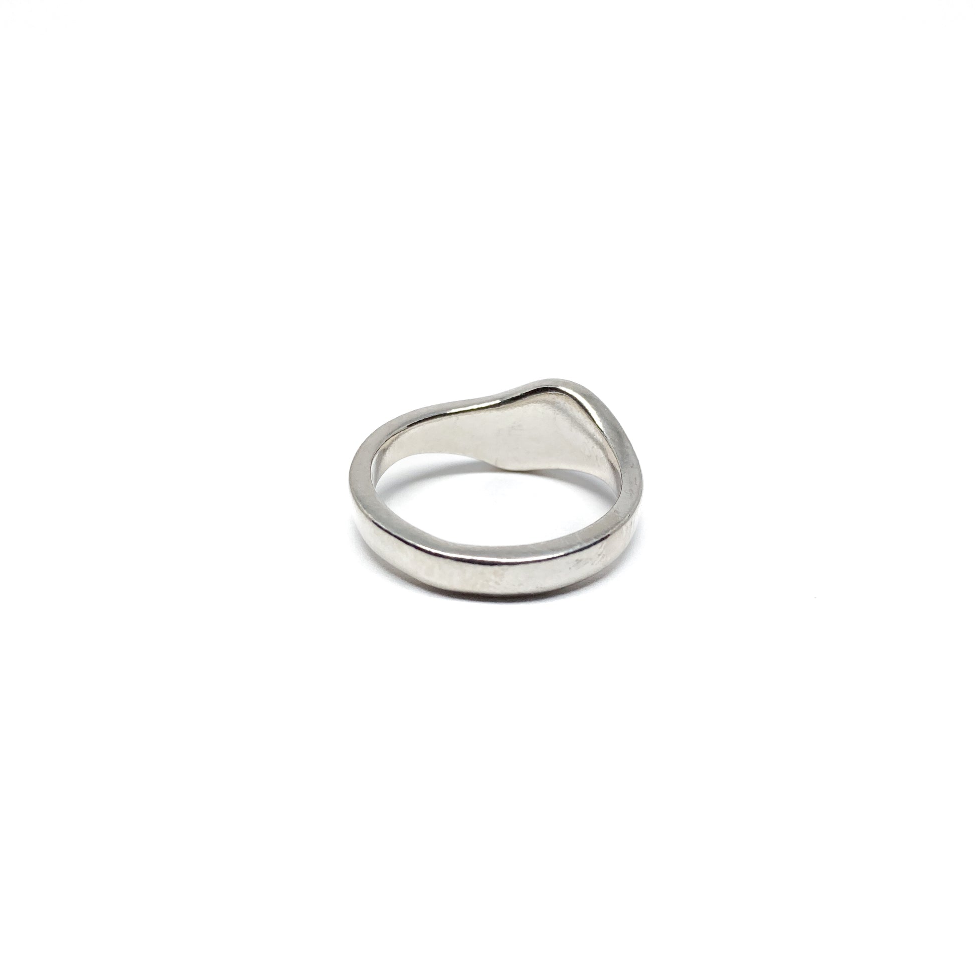 Modern silver ring with a smooth, curved design.