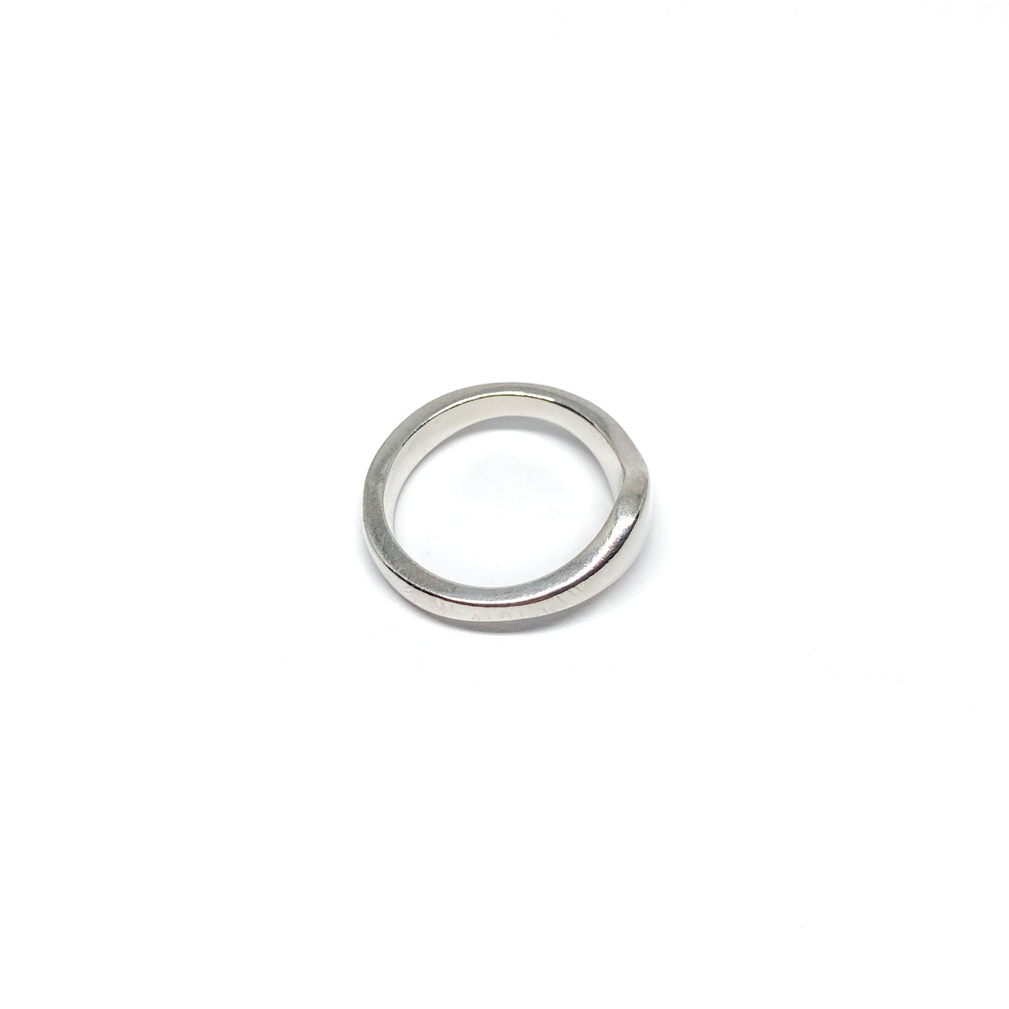 Modern silver ring with a smooth, curved design.