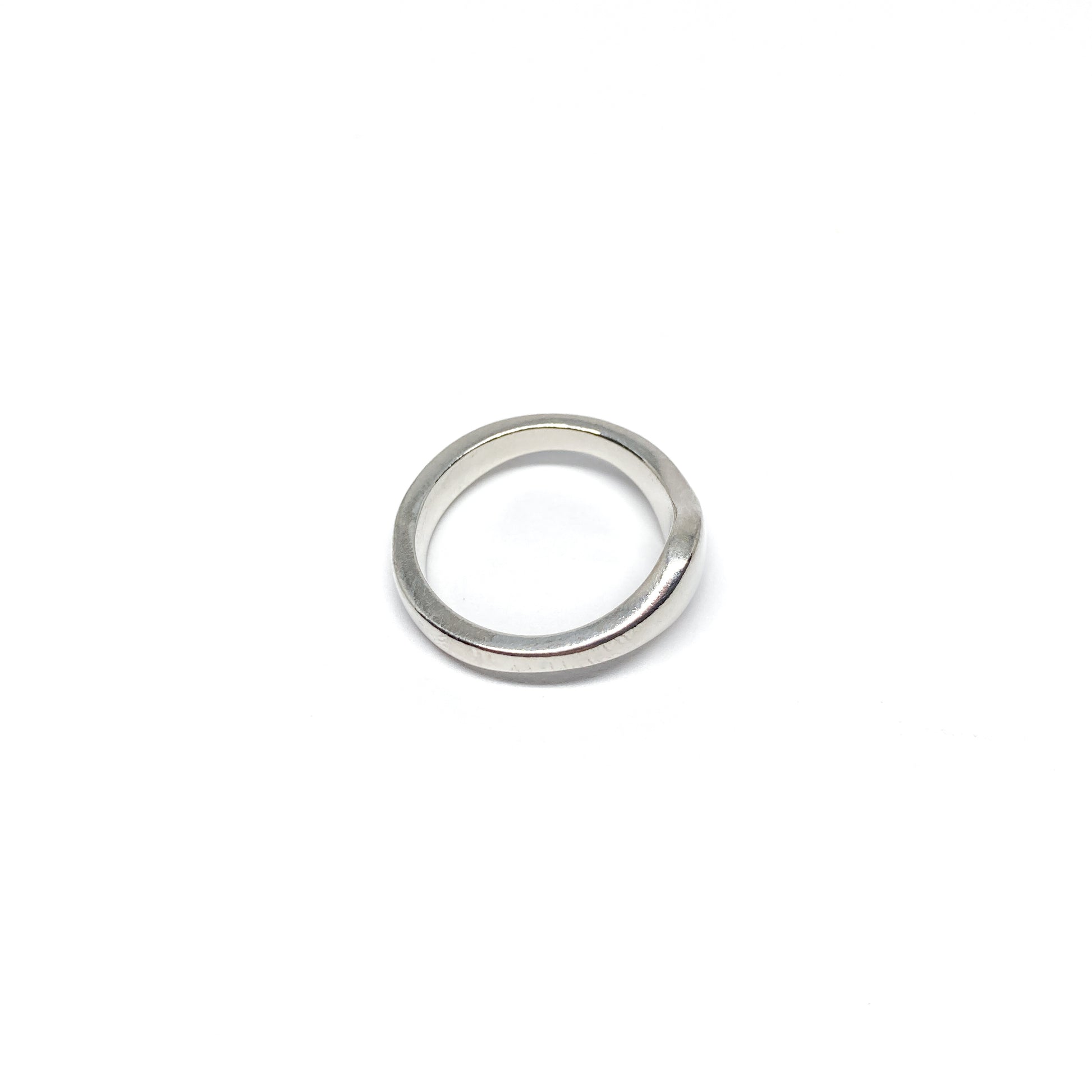 Modern silver ring with a smooth, curved design.