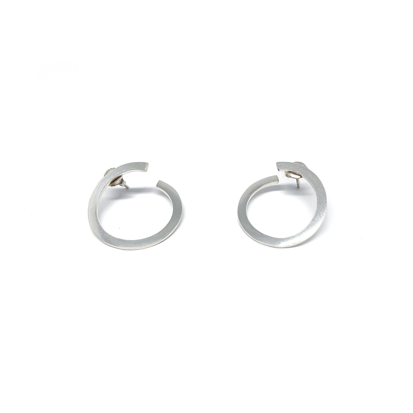 Modern silver hoop earrings, open design.