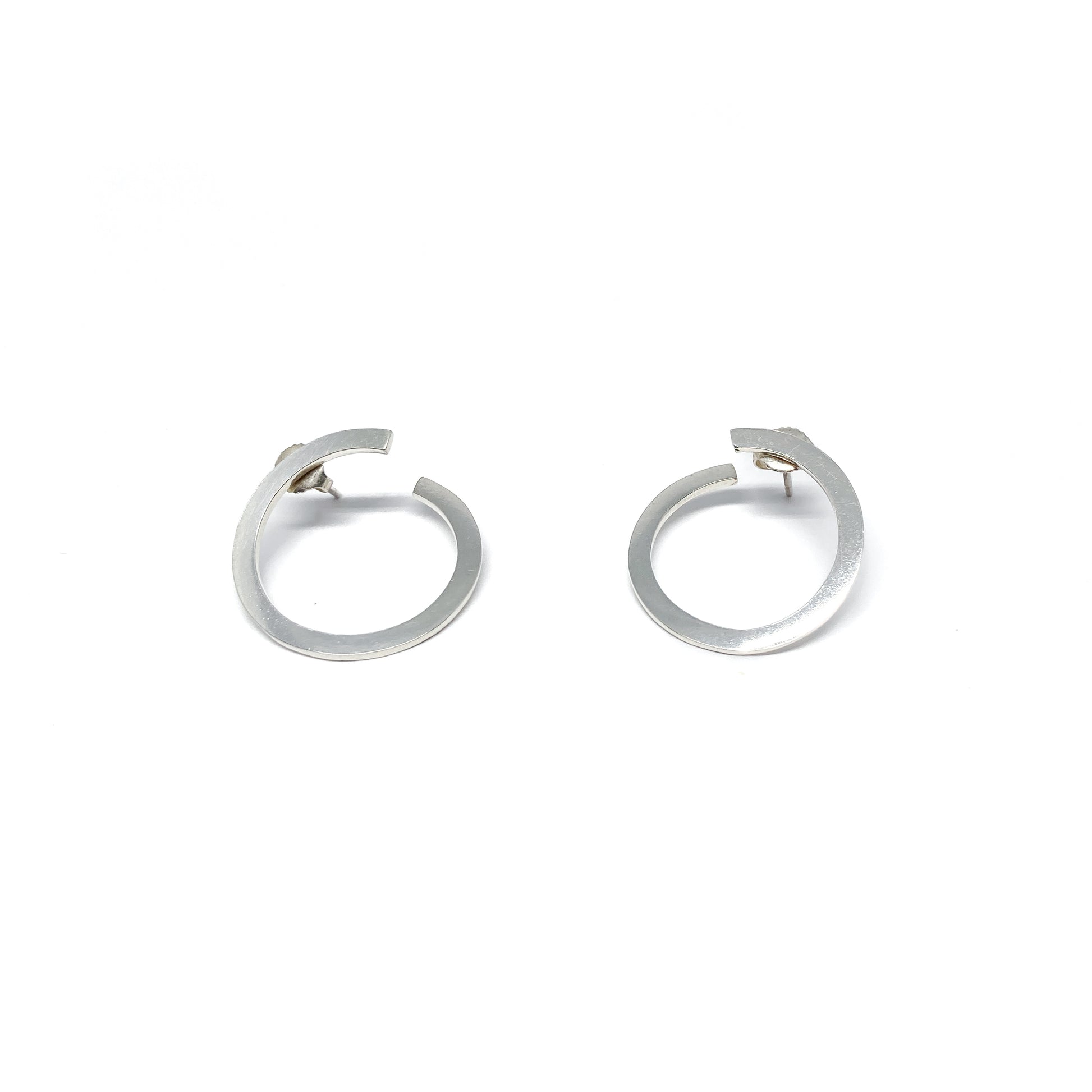 Modern silver hoop earrings, open design.