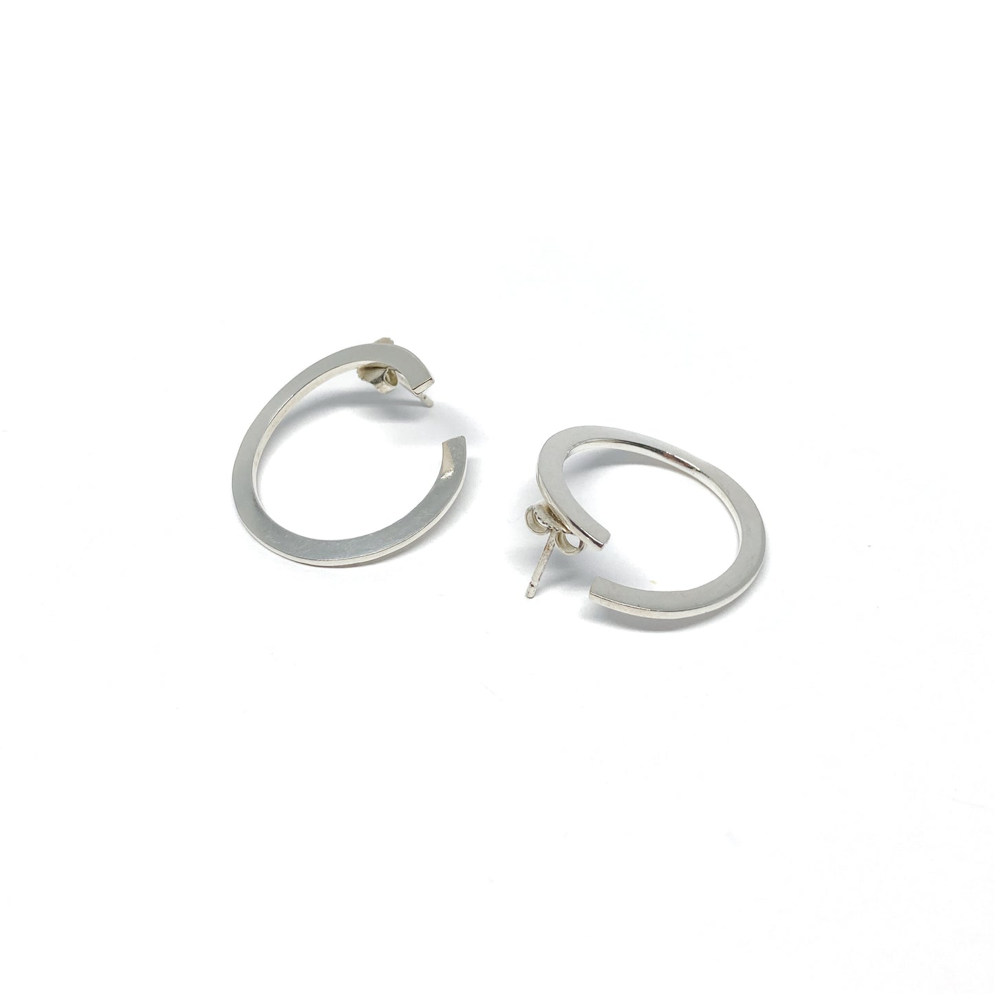 Modern silver hoop earrings, open design.