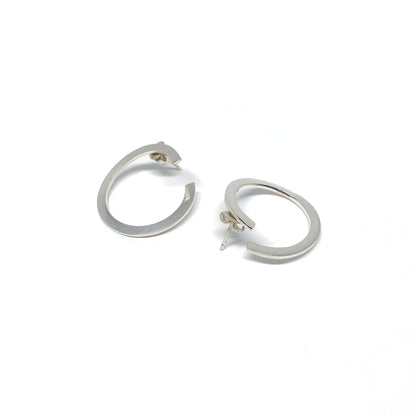 Modern silver hoop earrings, open design.