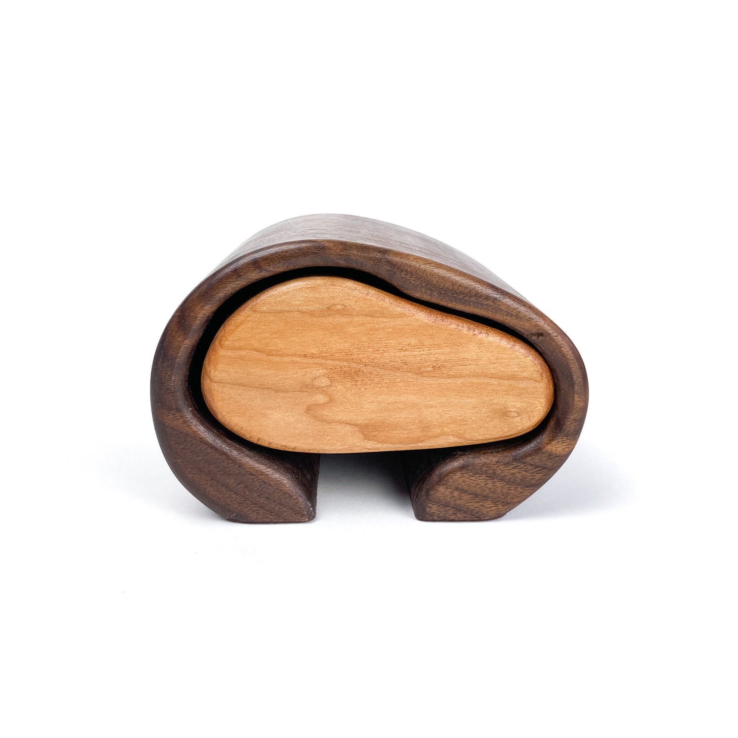 Handcrafted wooden jewelry box with a smooth, light-toned sliding drawer nestled within a darker, curved outer shell.