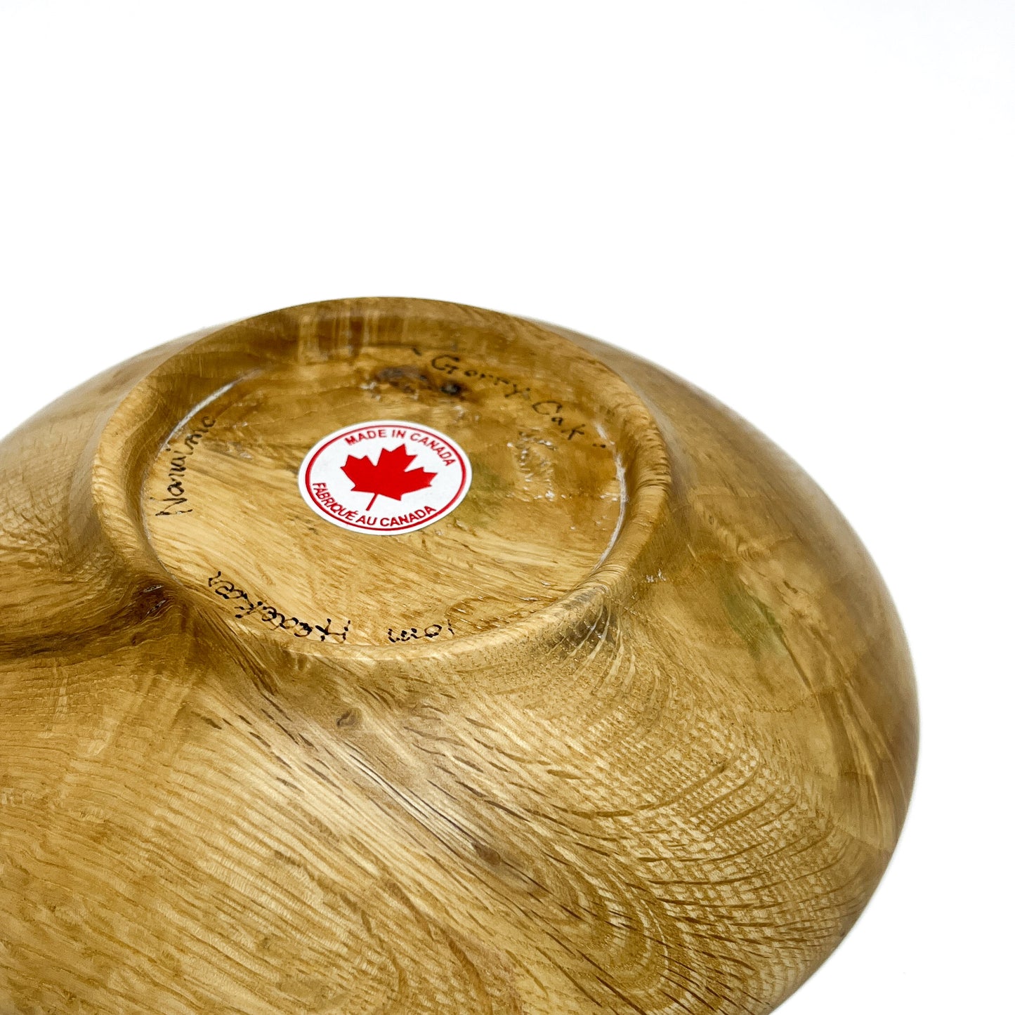 The underside of a Rare Garry Oak Candy Dish, showing the "Made in Canada" sticker and artist's markings.