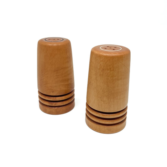 A pair of wooden Flared Arbutus Salt & Pepper shakers standing upright, showing their tops with shaker holes.