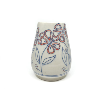 A white ceramic vase with a flared shape features hand-painted blue floral outlines with reddish-orange petal details and a light green inner glaze.