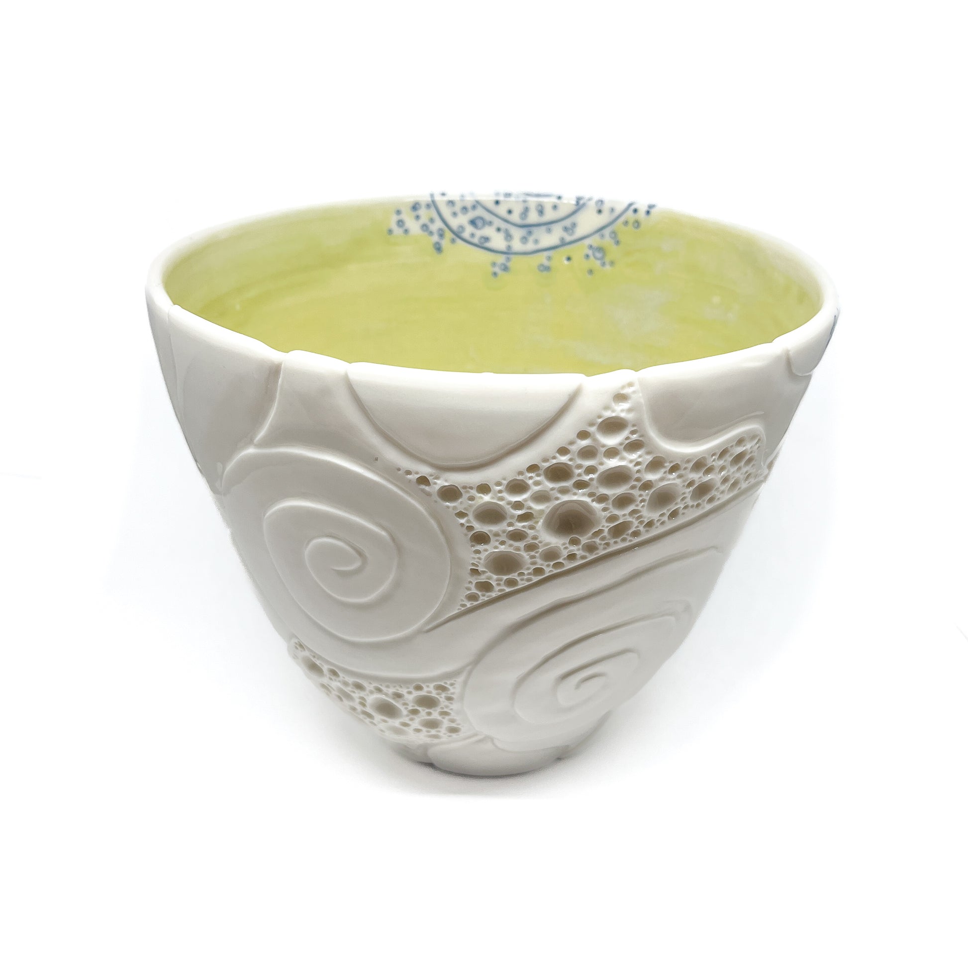 Small ceramic bowl with textured swirl and bubble patterns, and a blue decorative rim.