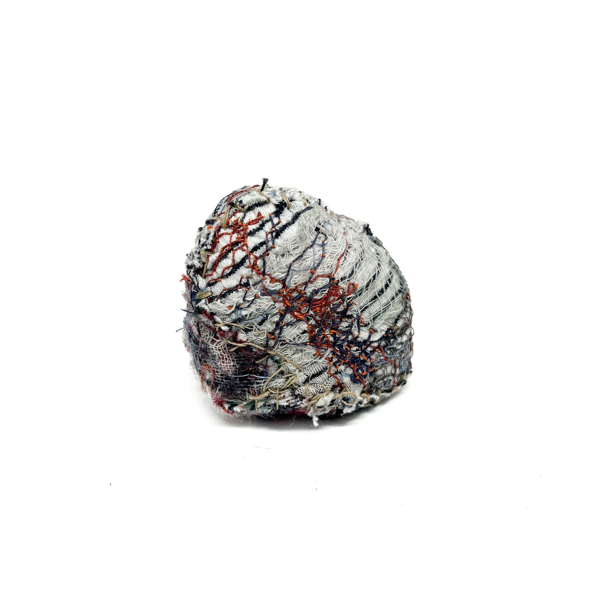 Embroidered Rock by Jane Kenyon: Round textured textile art resembling a rock, with dense gray and white thread stitching and subtle color accents.