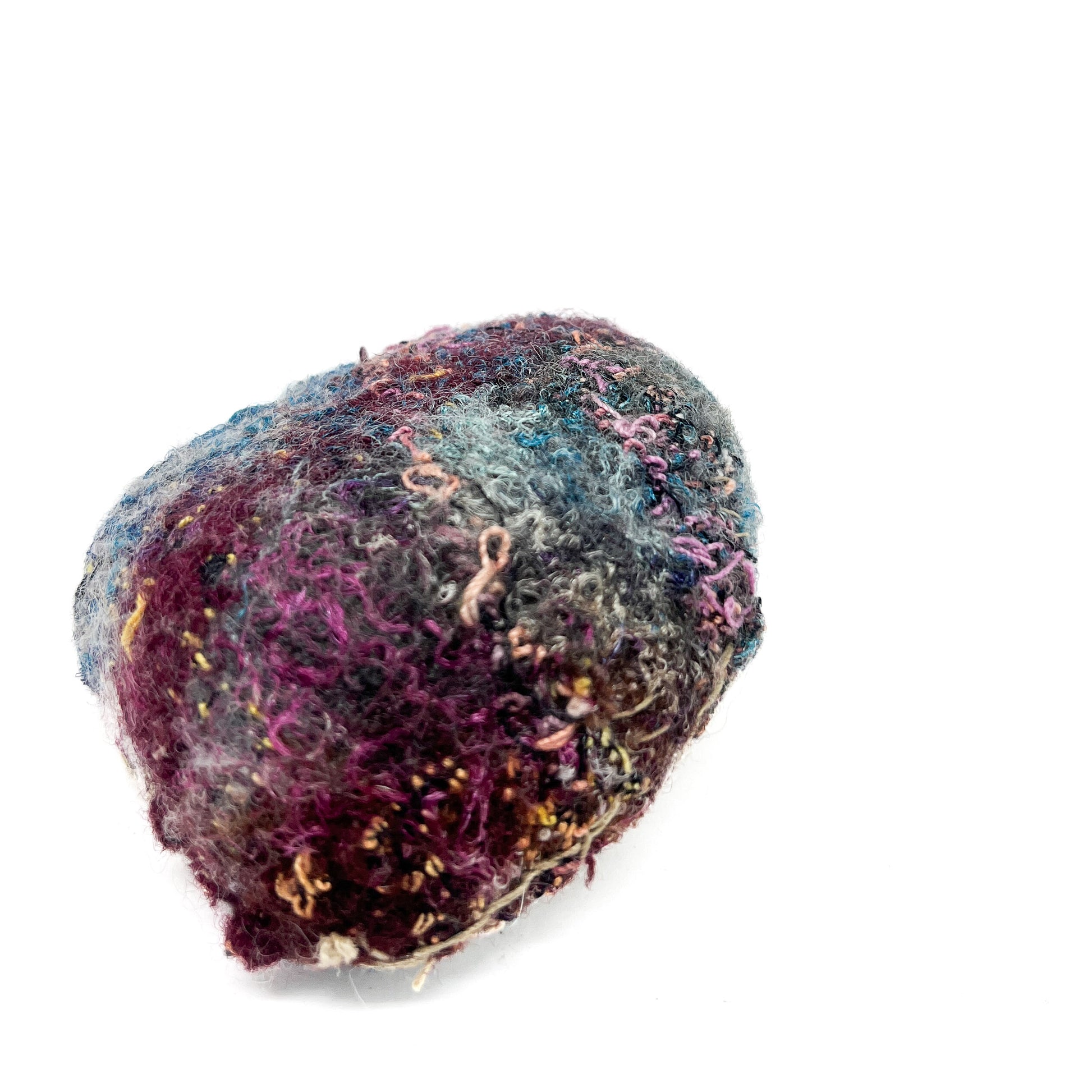 Embroidered Rock by Jane Kenyon: Round textured textile art resembling a rock, with a dense mix of purple, blue, gray, and gold thread.