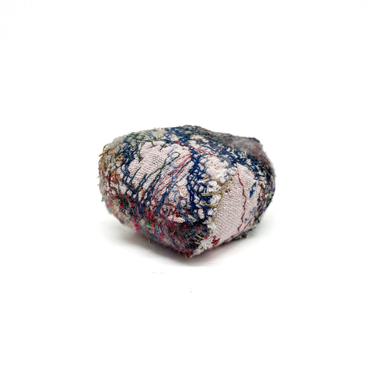 Embroidered Rock by Jane Kenyon: Round textured textile art resembling a rock, with intricate stitching in various colorful threads.