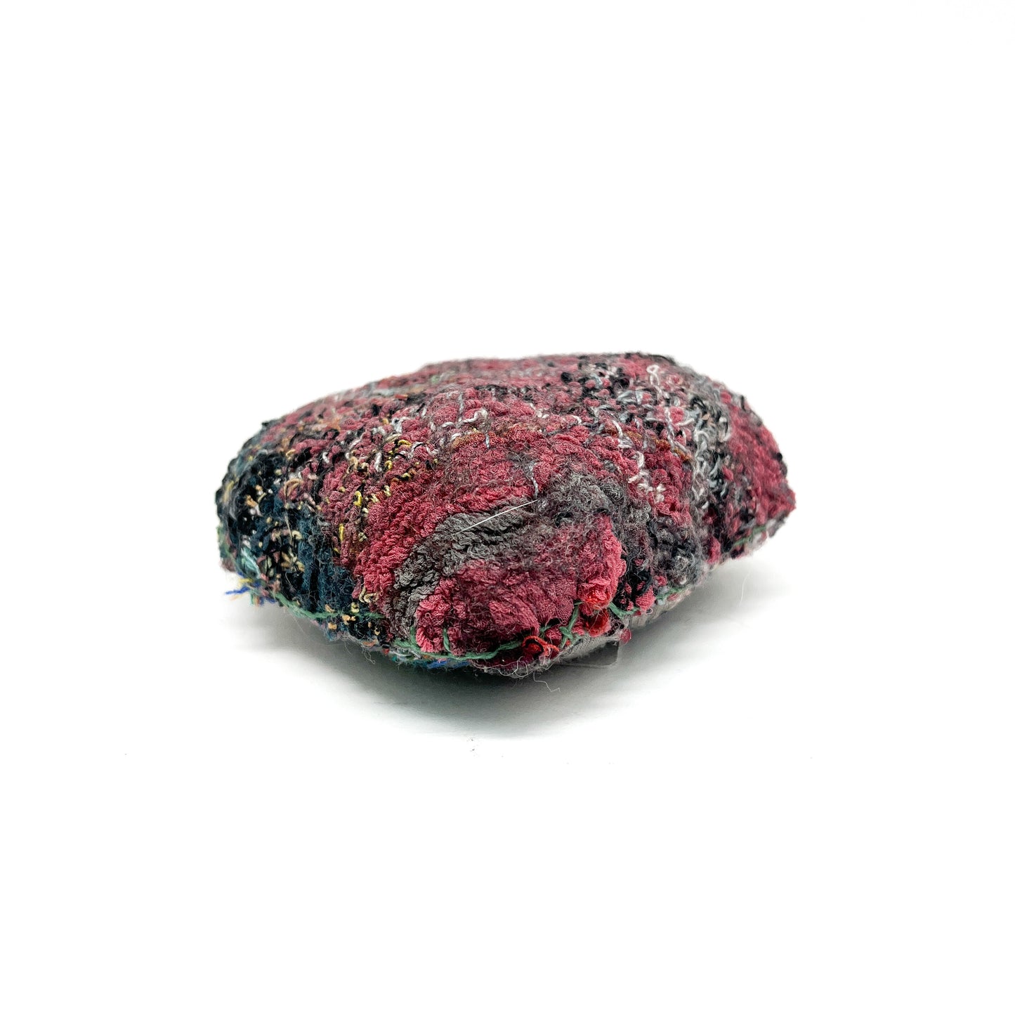 Embroidered Rock: Oval textured textile art resembling a rock, with deep red, gray, and black thread stitching.