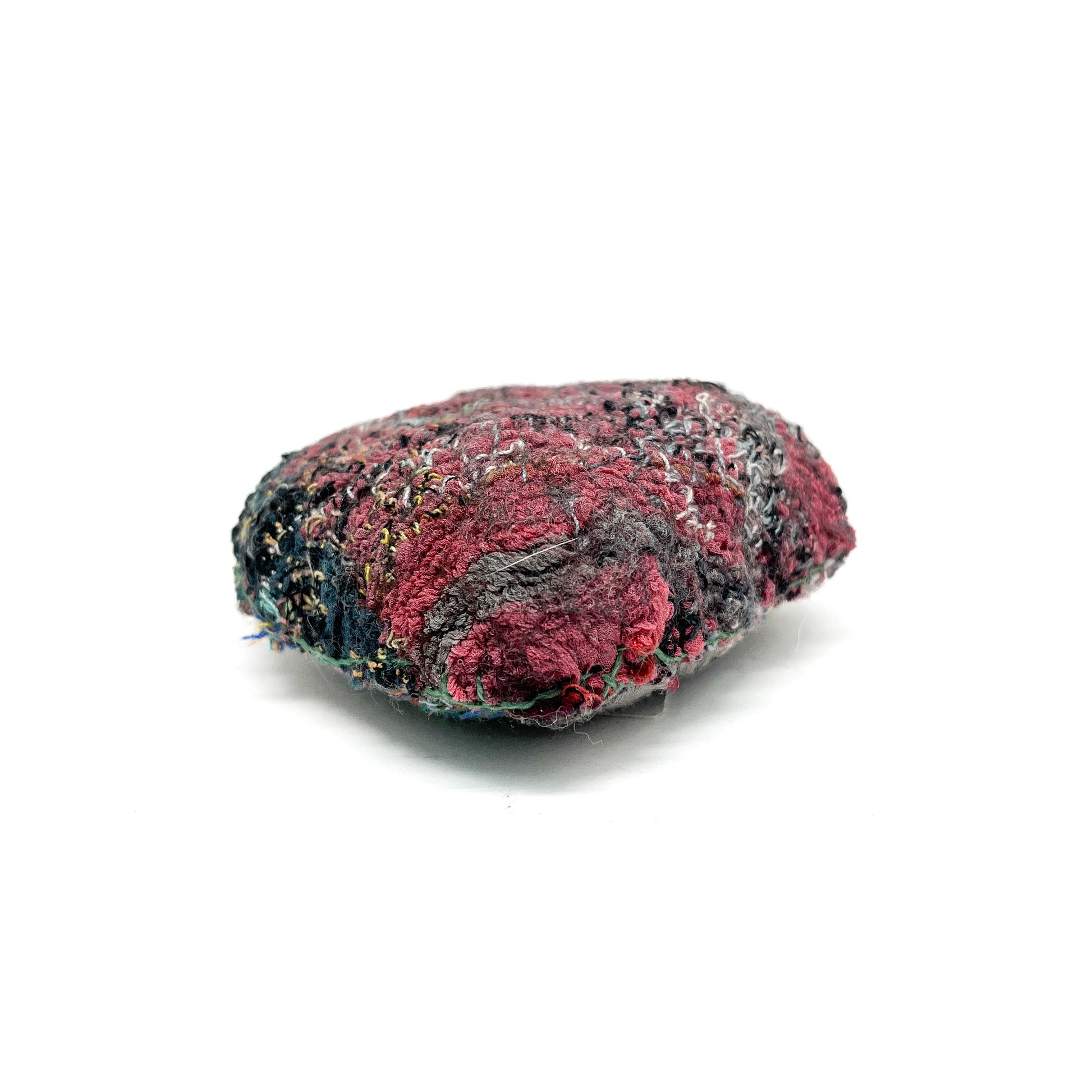 Embroidered Rock: Oval textured textile art resembling a rock, with deep red, gray, and black thread stitching.