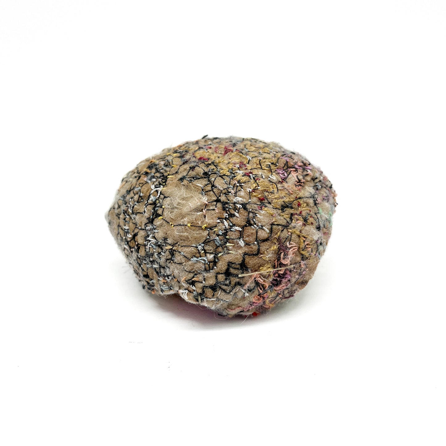 Embroidered Rock: Round textured textile art resembling a rock, with detailed stitching in earth tones and black threads.