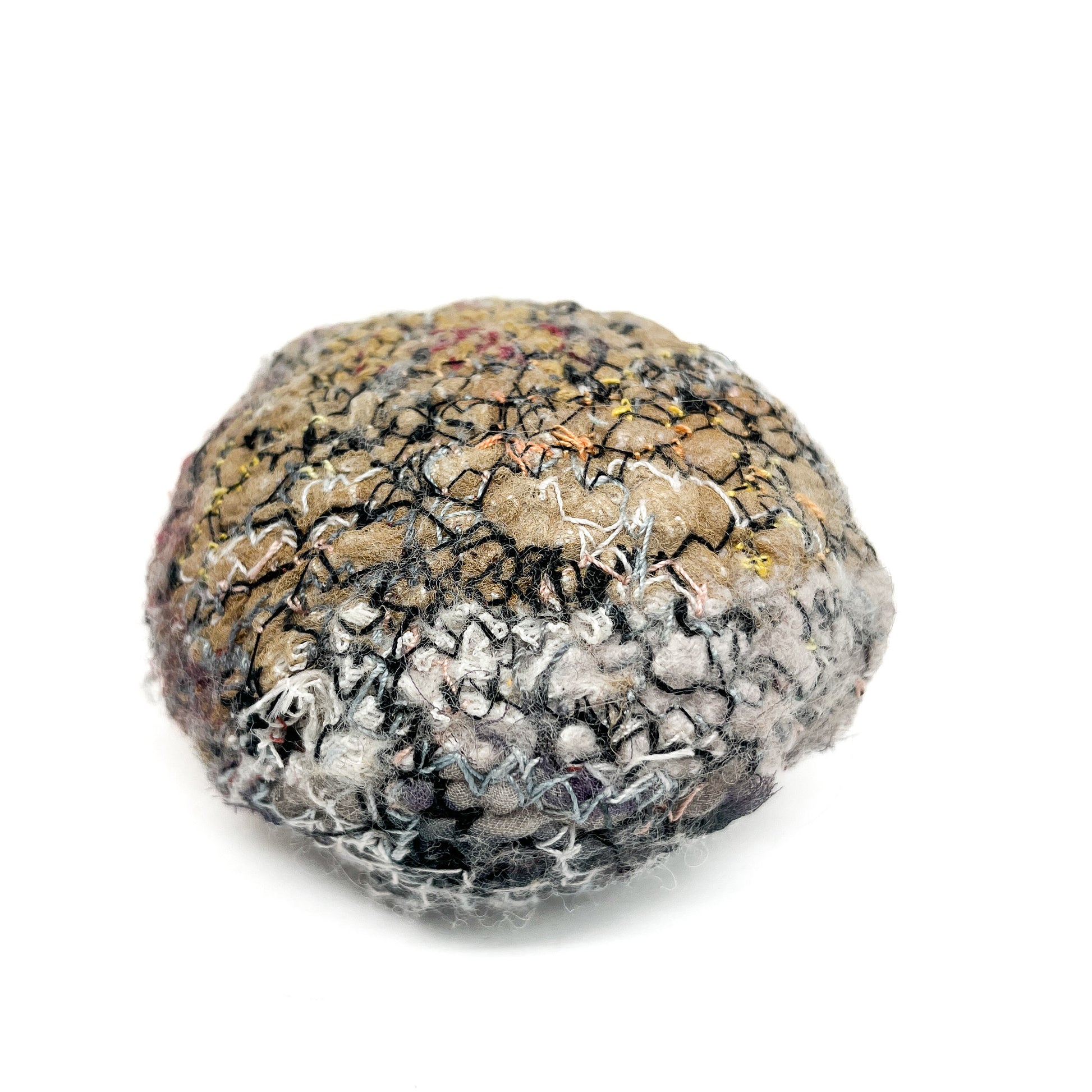Embroidered Rock: Round textured textile art resembling a rock, with layers of gray, black, and tan thread stitching.