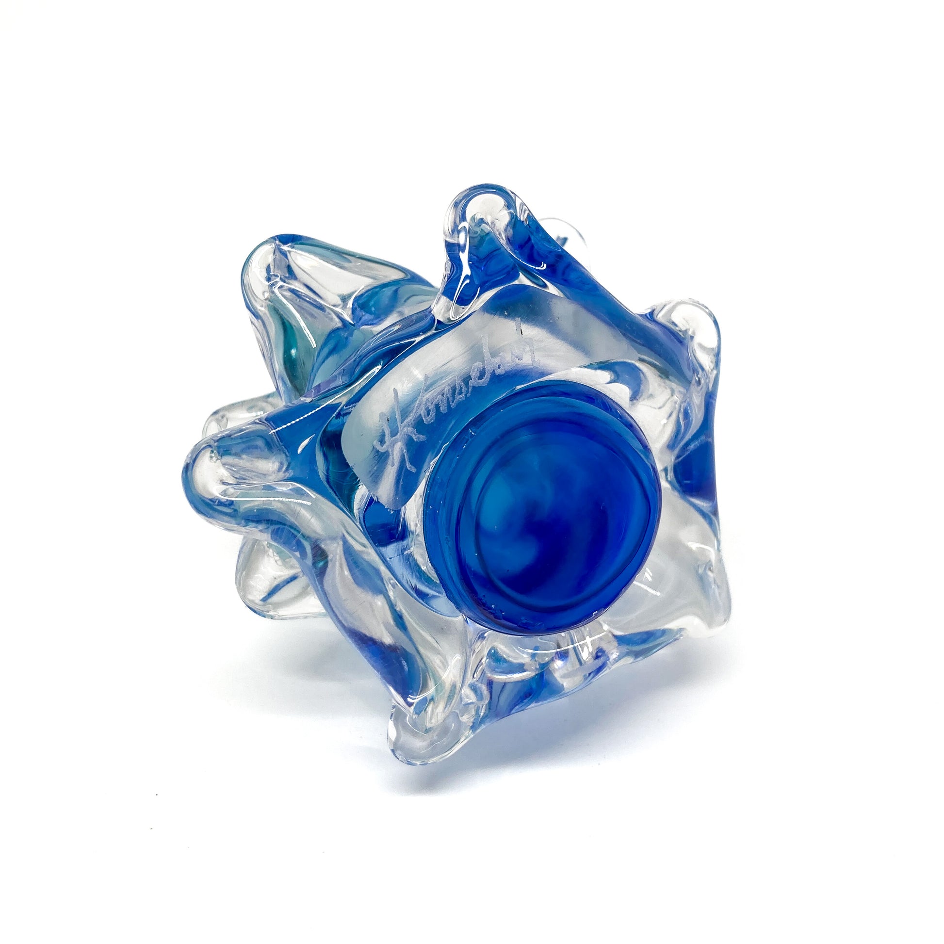 The bottom of a clear glass Christmas tree with blue swirls.