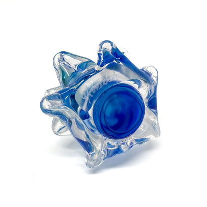 The bottom of a clear glass Christmas tree with blue swirls.