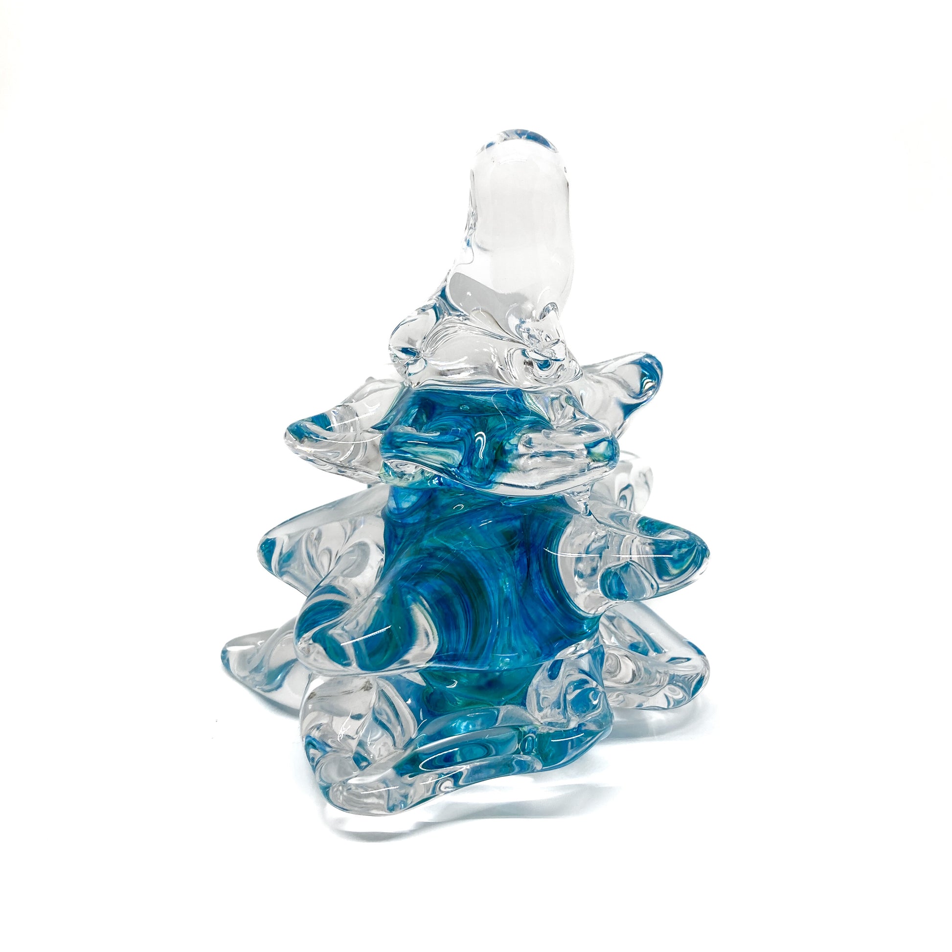 A medium, clear glass Christmas tree with blue swirls.