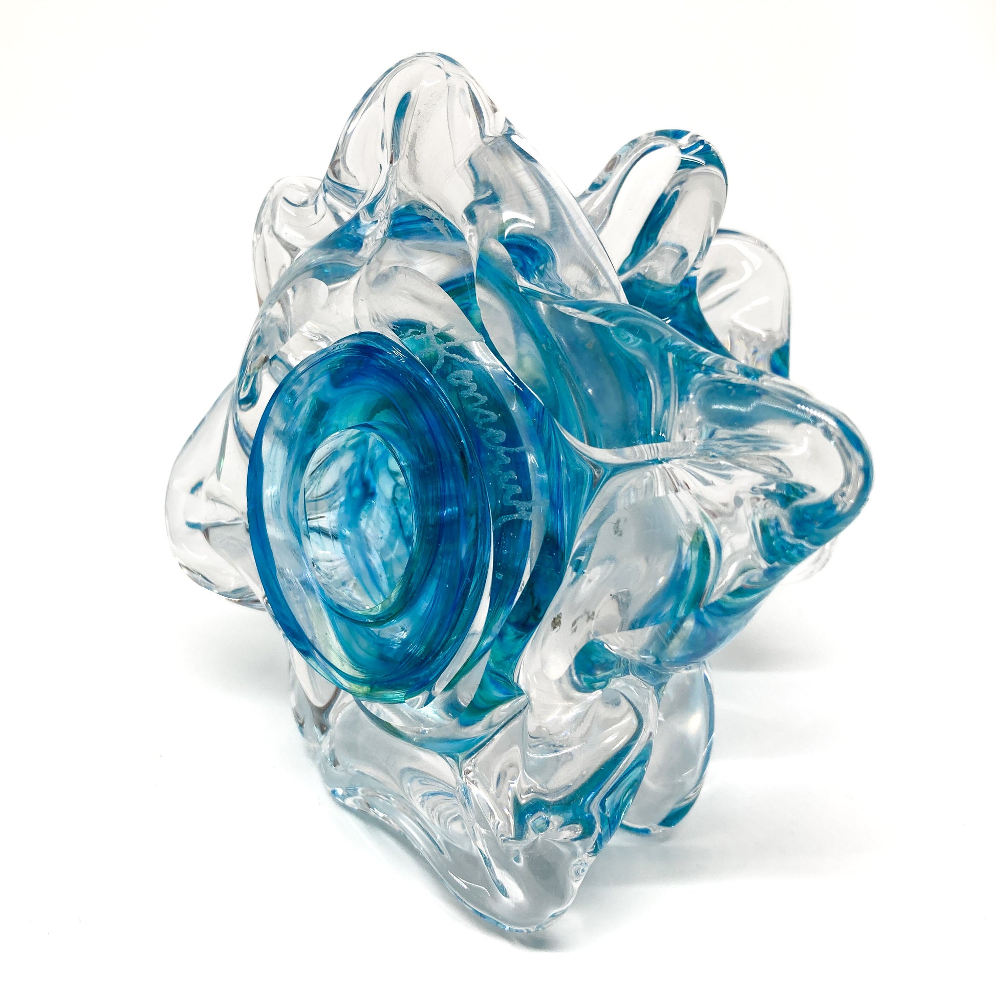 The bottom of a clear glass Christmas tree with blue swirls.