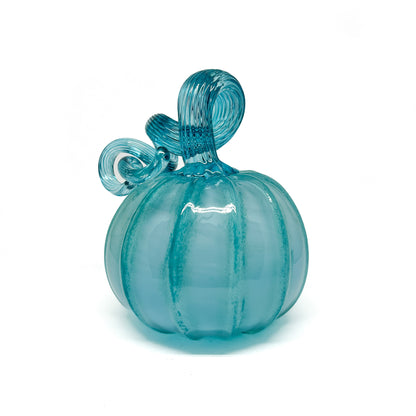 A light blue glass pumpkin with a curled, light blue glass stem.