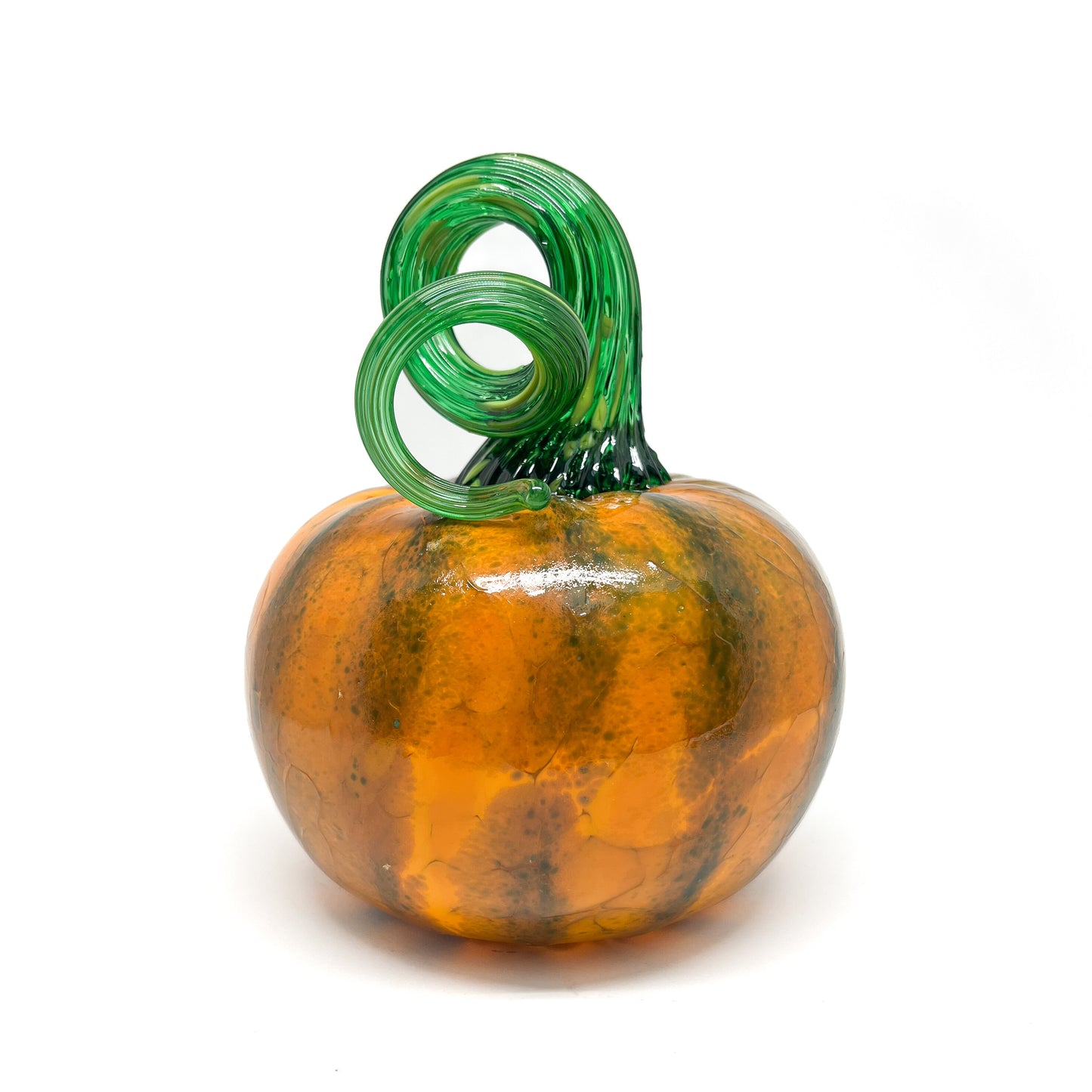 A glass pumpkin with orange and green stripes, featuring a curled green stem.