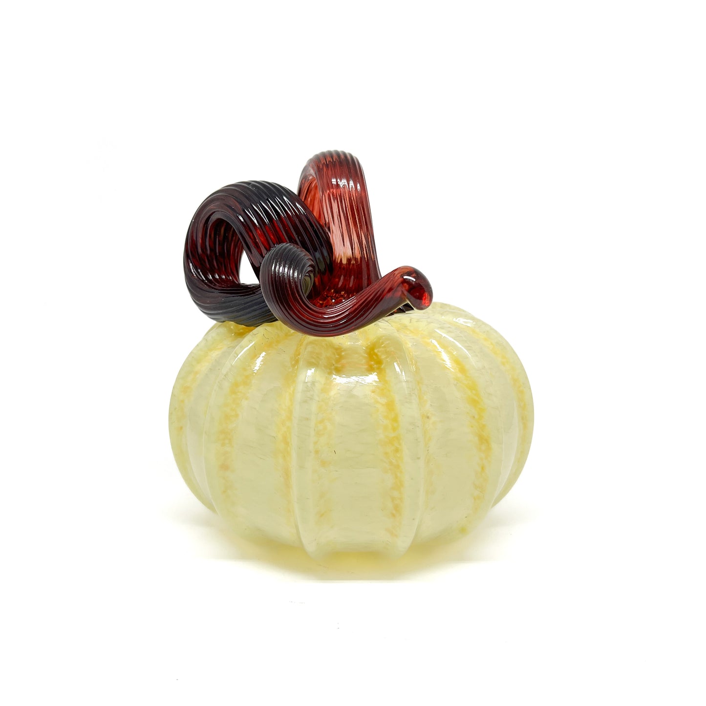 A pale yellow glass pumpkin with a curled, dark red glass stem.
