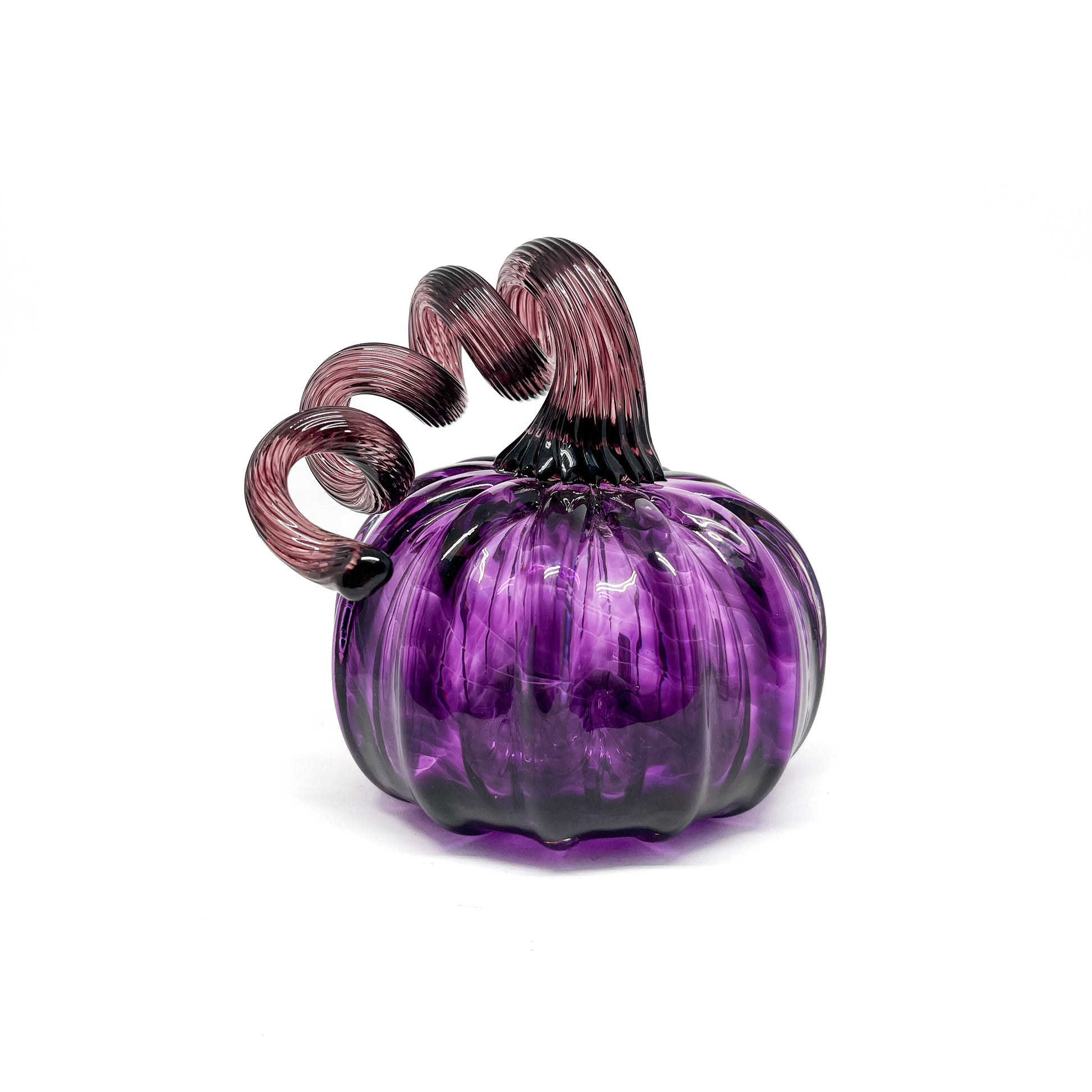 A purple glass pumpkin with a curled, deep purple glass stem.