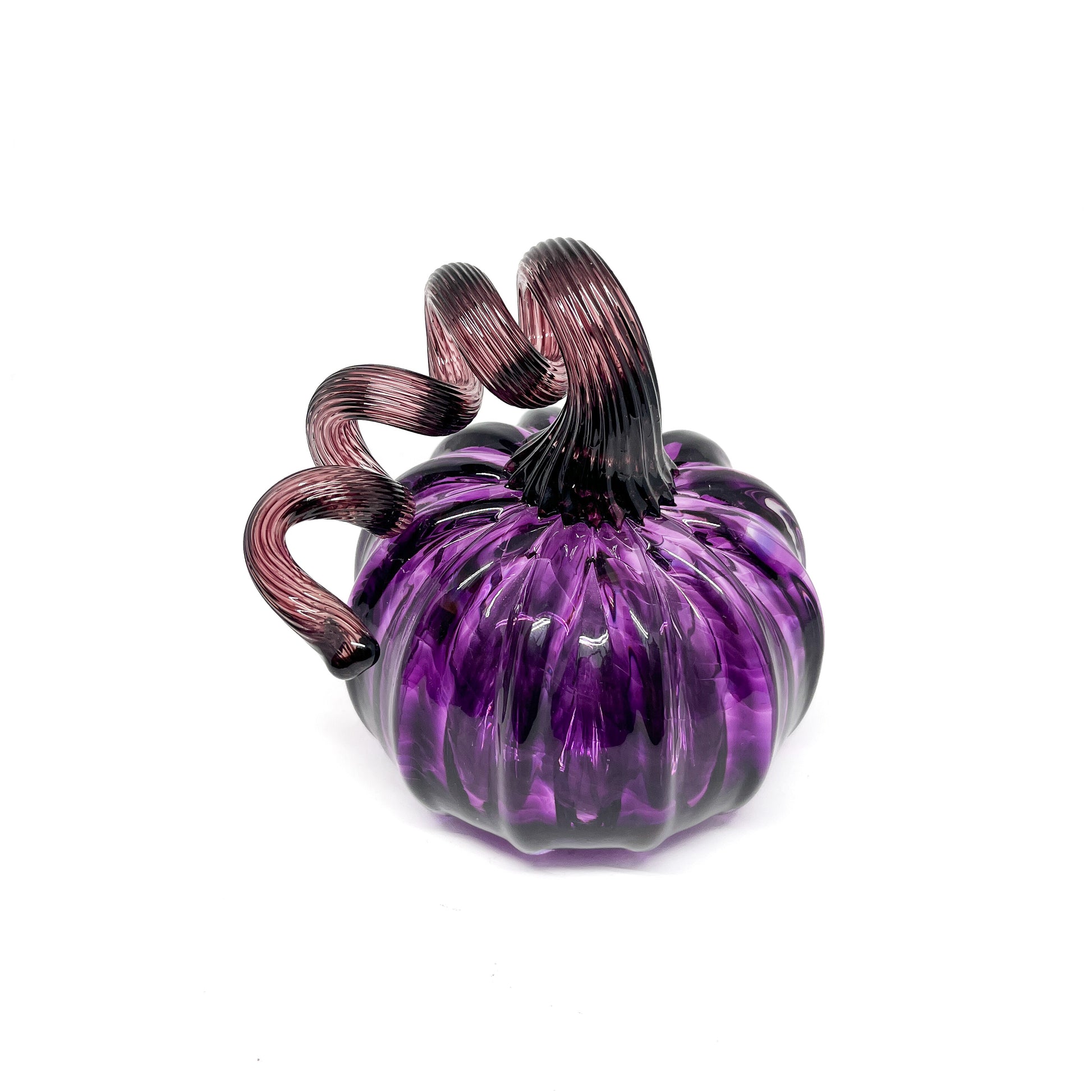 A purple glass pumpkin with a curled, deep purple glass stem.