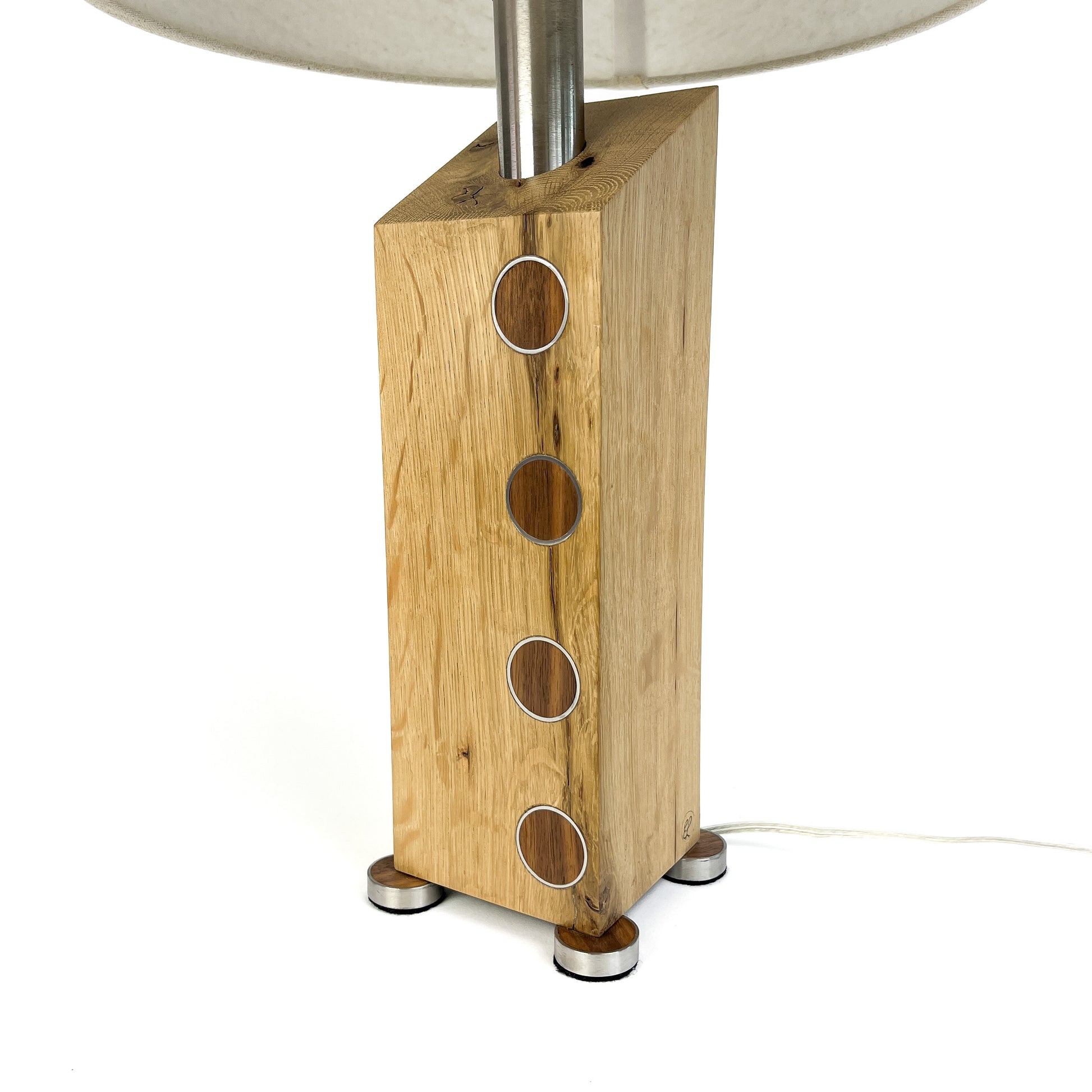 Lamp base: light wood block with metal circles, small metal feet, and a metal rod.