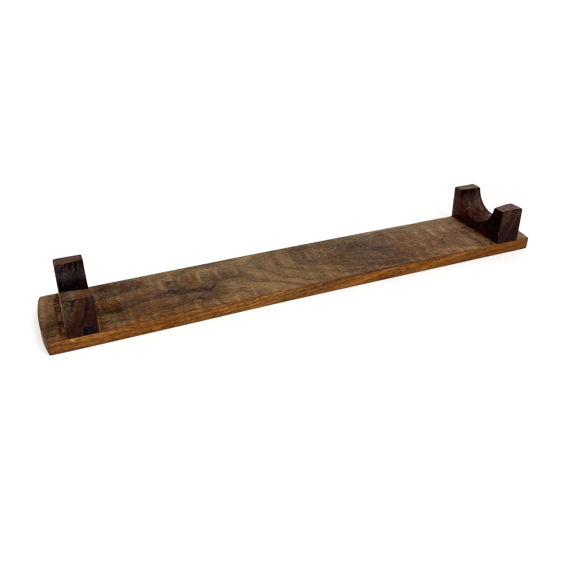 A dark wooden French rolling pin stand with two carved supports, angled diagonally. The stand has a visible wood grain.