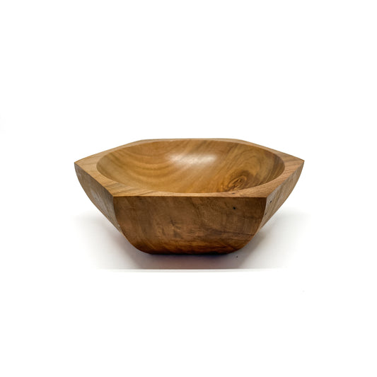 A six-sided wooden bowl with visible grain and a smooth, carved interior. The bowl has a shallow depth.