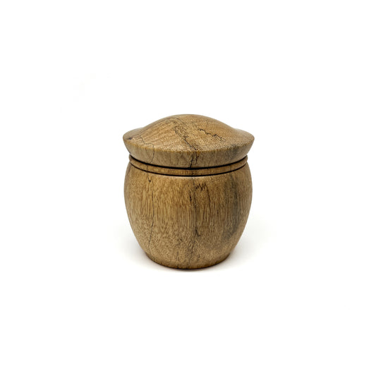 Hand-turned wooden lidded pot with natural wood grain visible.