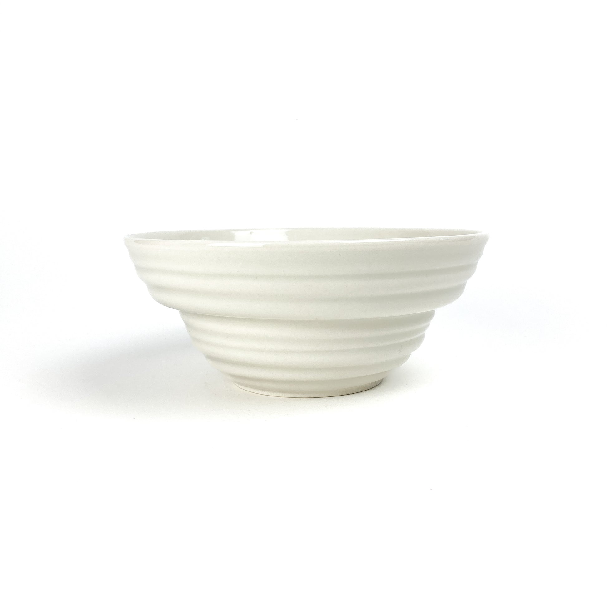 A ceramic donburi bowl with horizontal ridges forming a stepped, conical shape and a smooth, wide opening.